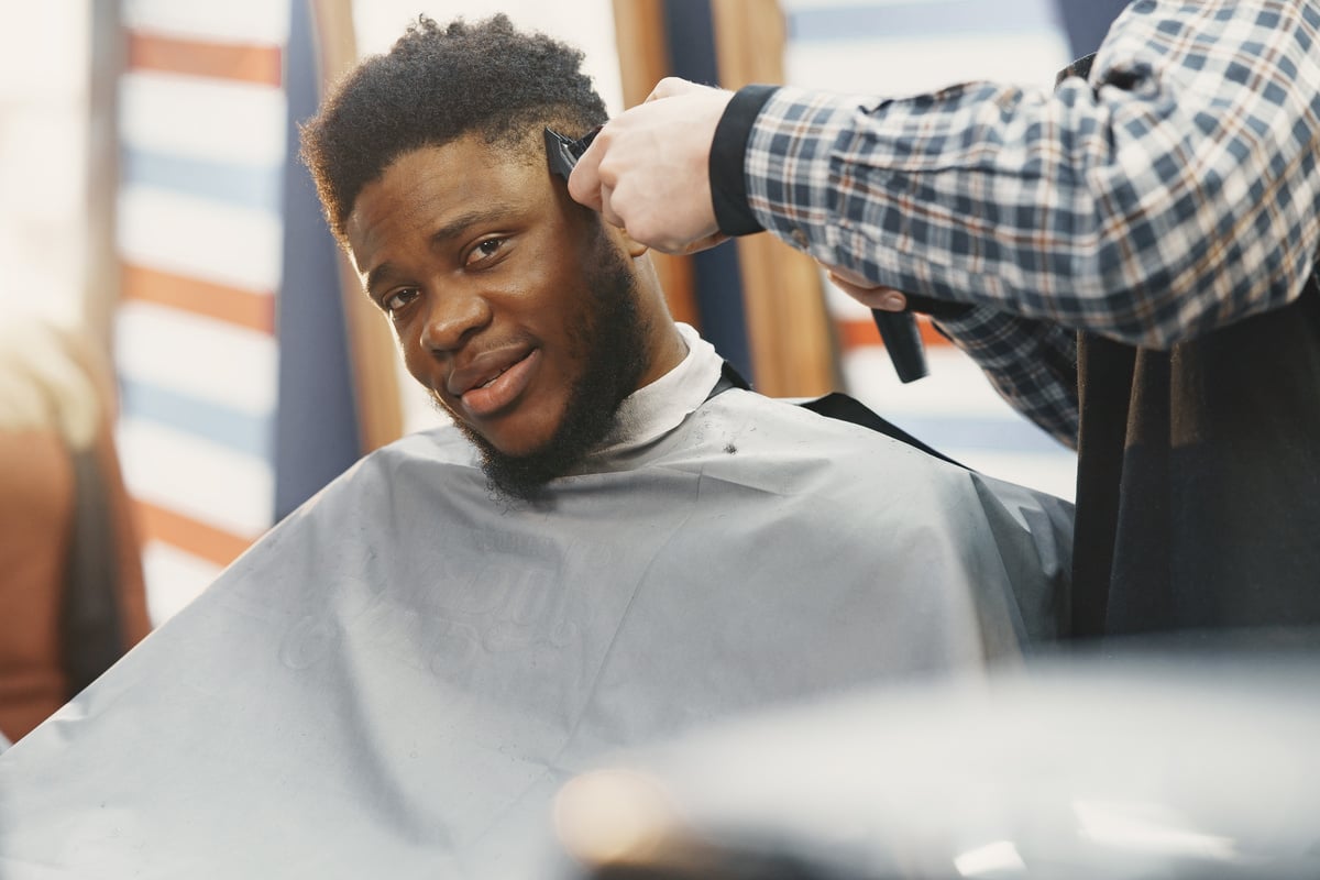 Man Receiving Haircut at Barber Shop